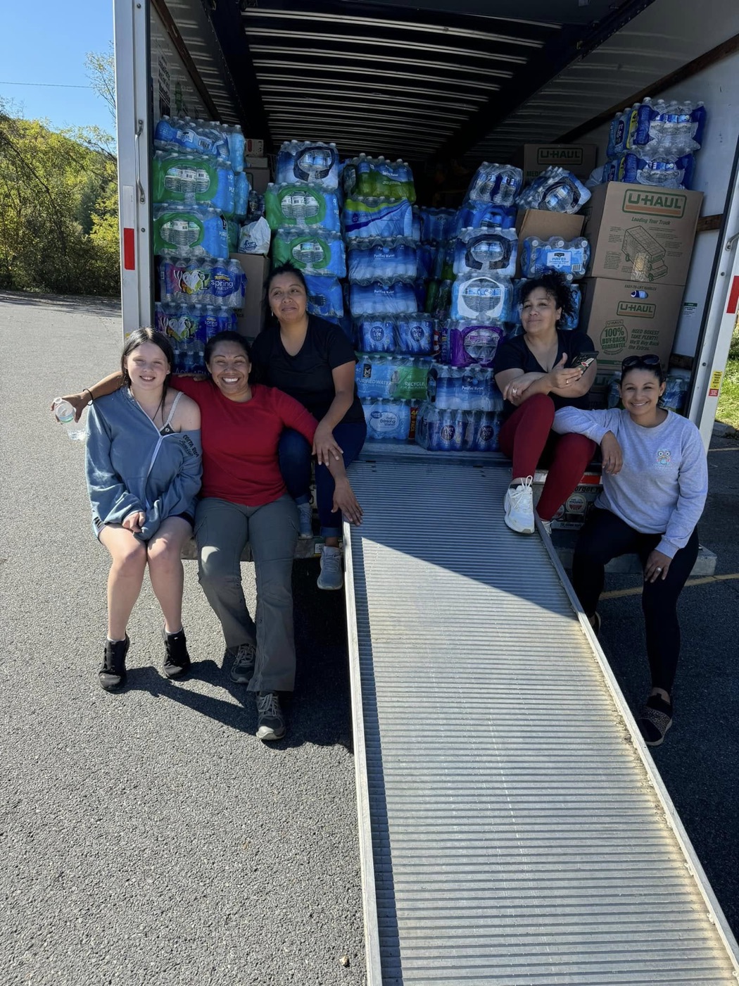 Volunteers with a truck full of donated water and supplies