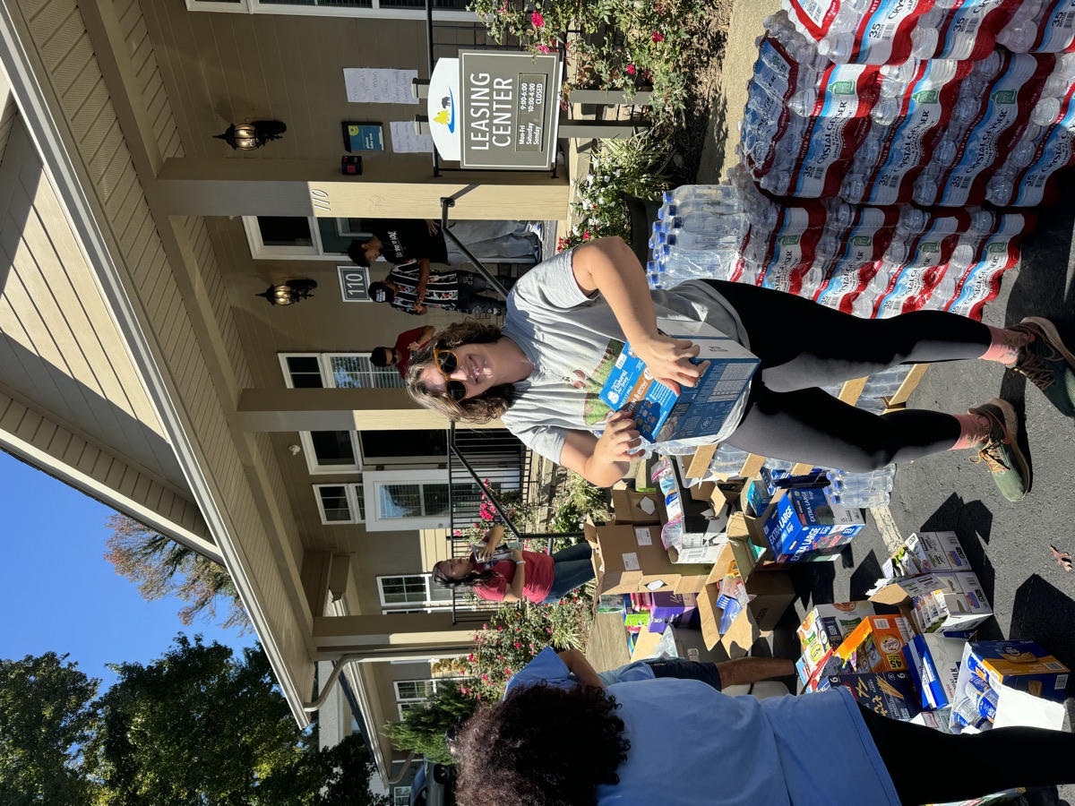 Hands of Hope volunteer sorting donated food and water for distribution