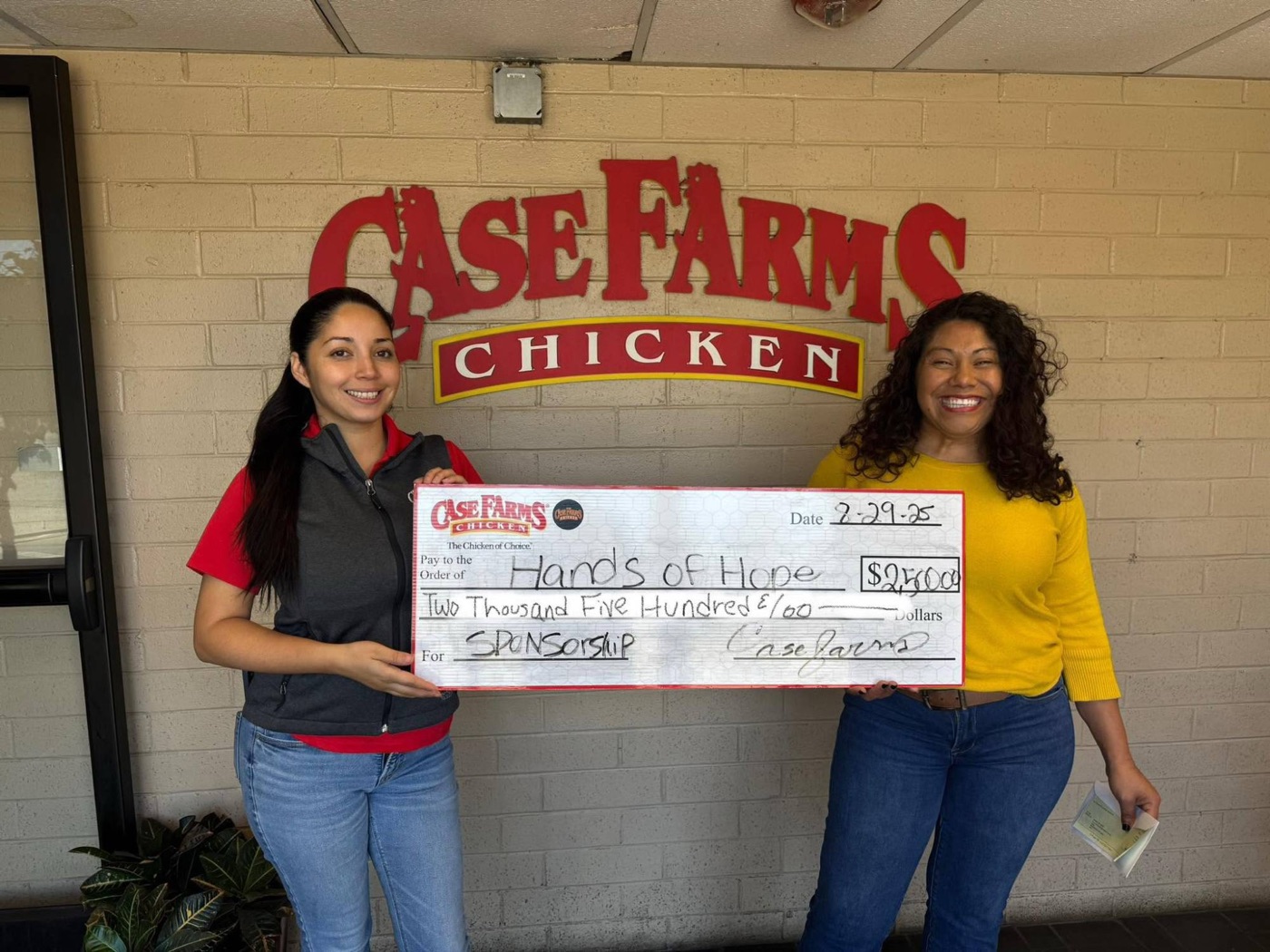 Case Farms Chicken presenting a $2,500 sponsorship check to Hands of Hope